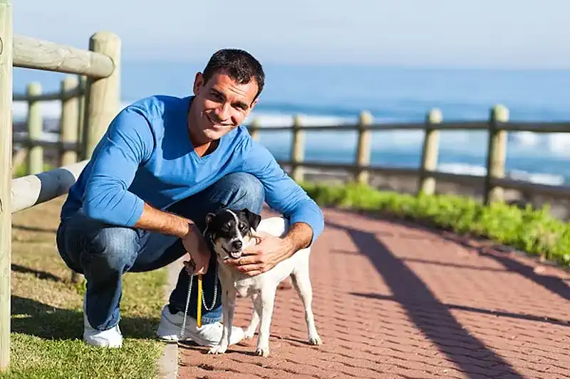 Smiling Owner Walking Dog